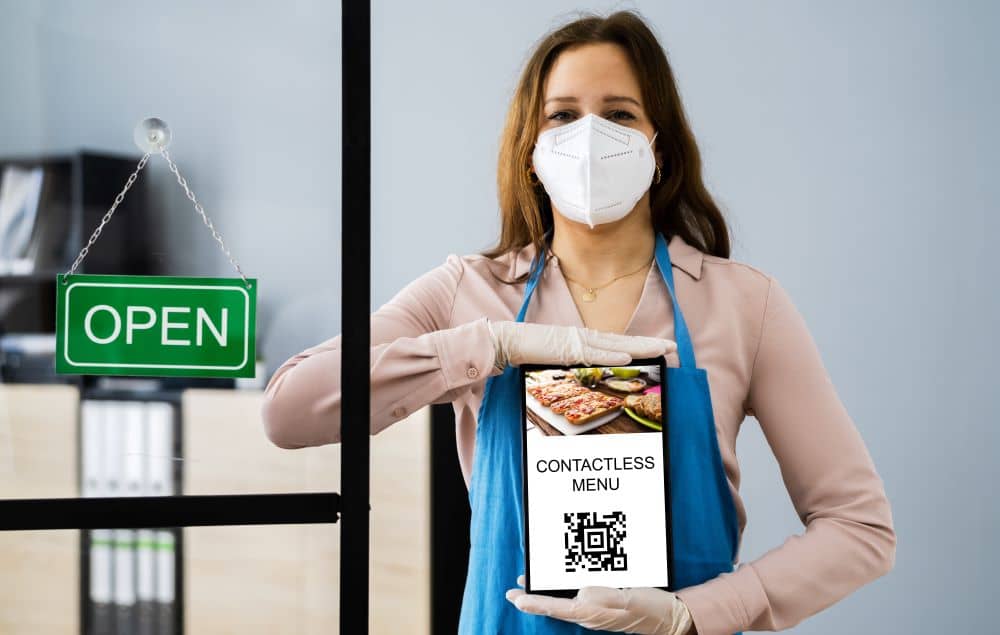 Woman holding contactless menu.