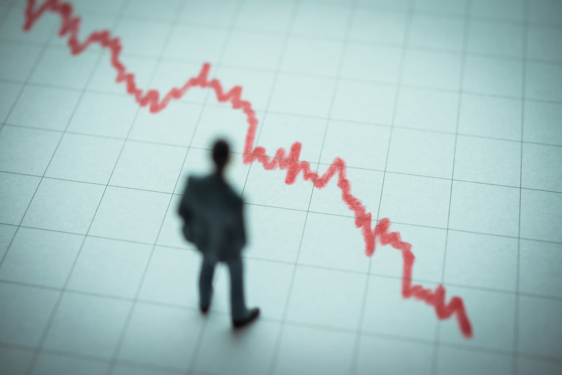 Business man looking at falling chart wondering what is insolvent trading