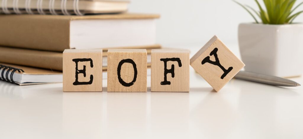 E-O-F-Y letters on wooden blocks in black signifying end of financial year for business tax returns